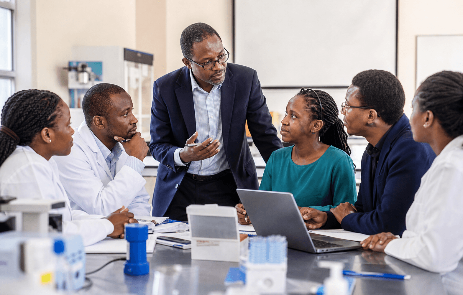 African researchers and fellows collaborating during a university pharmaceutical science training session